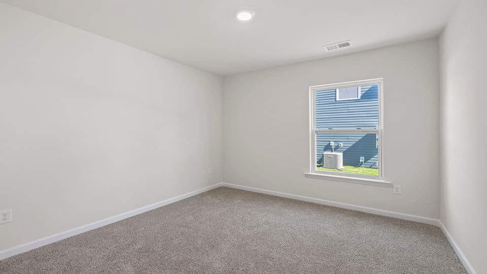 Bedroom with window and carpet.