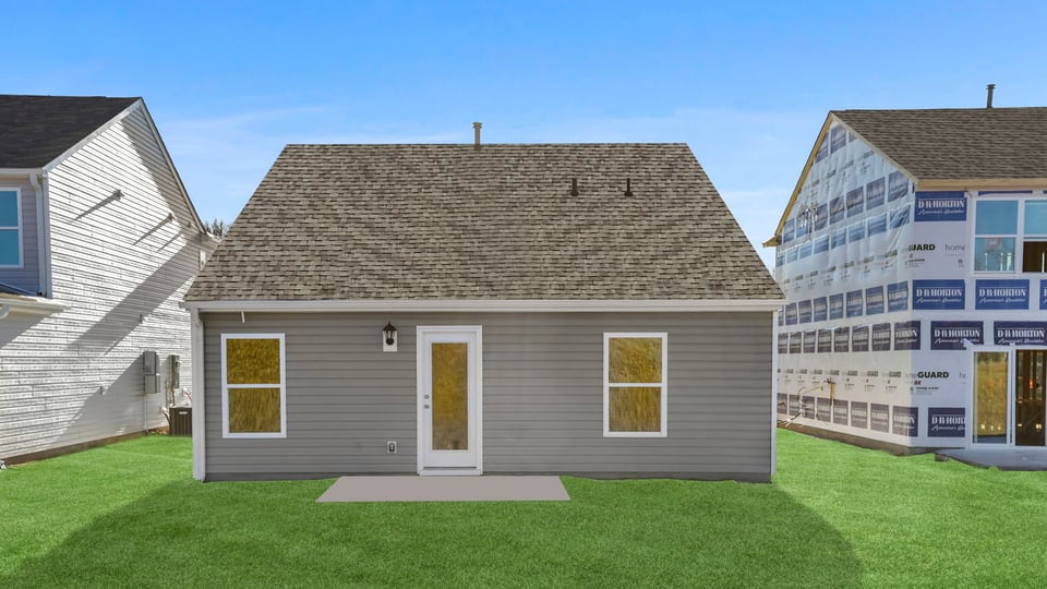 Back exterior of home with large backyard.