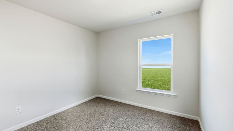 Bedroom with carpet and windows.