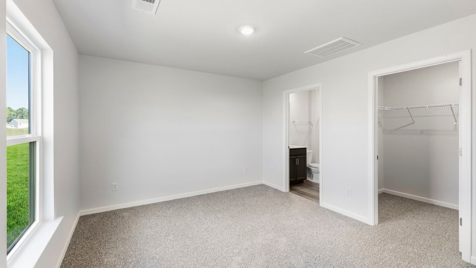 Bedroom with carpet and windows.