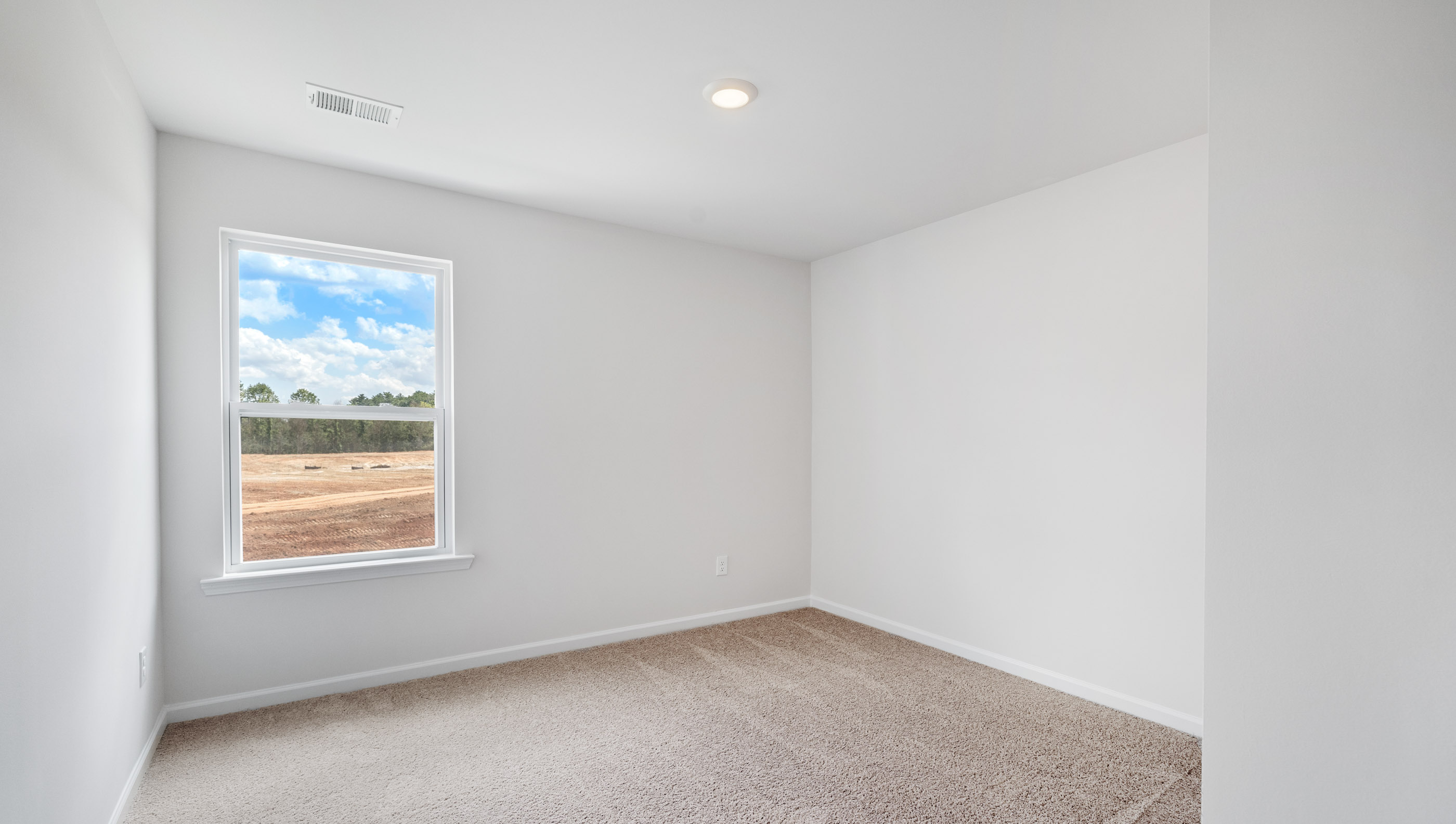 View of bedroom 1 with window and carpet.