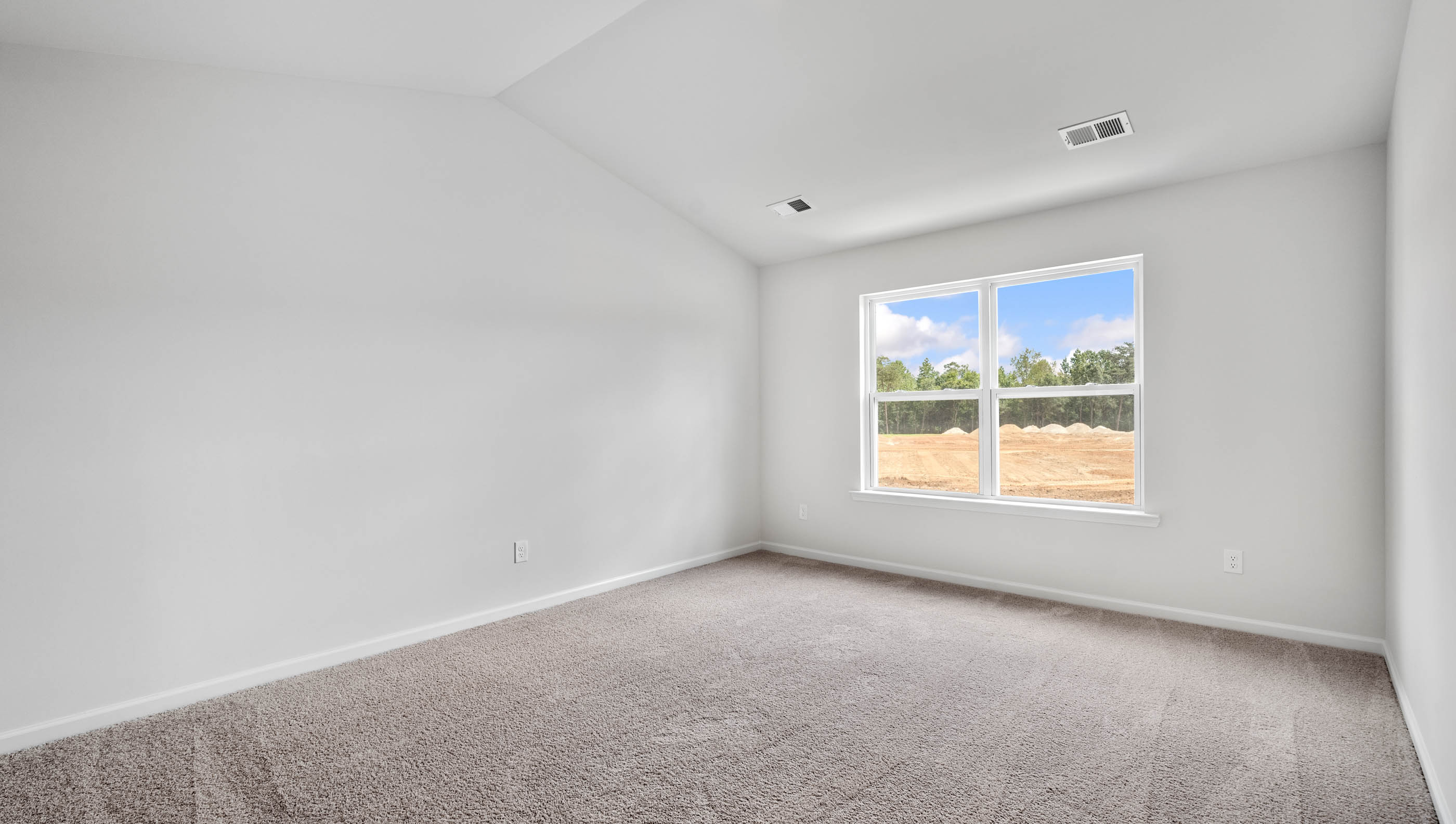 Primary bedroom with window and carpet.