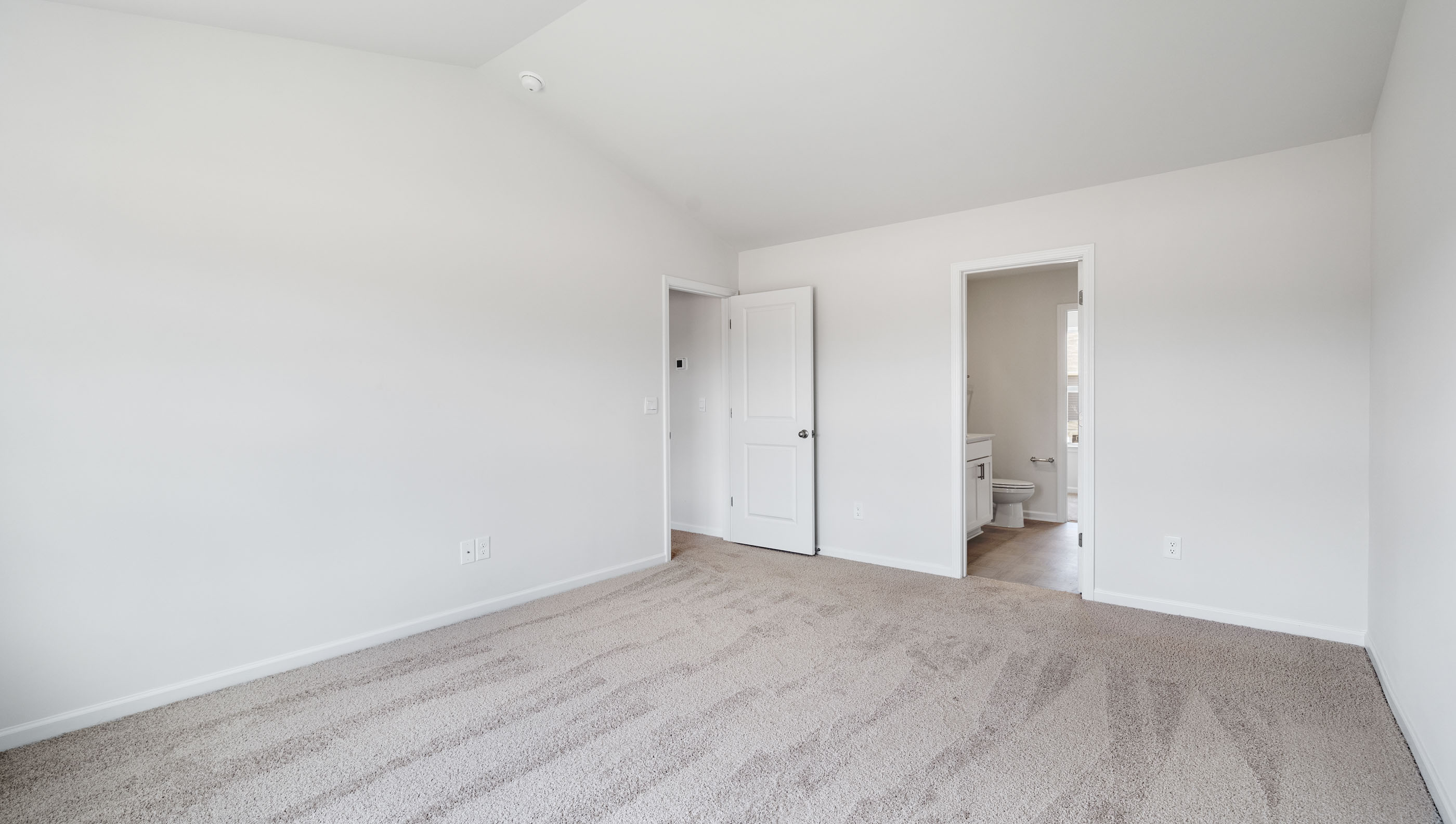 Primary bedroom with carpet floors.