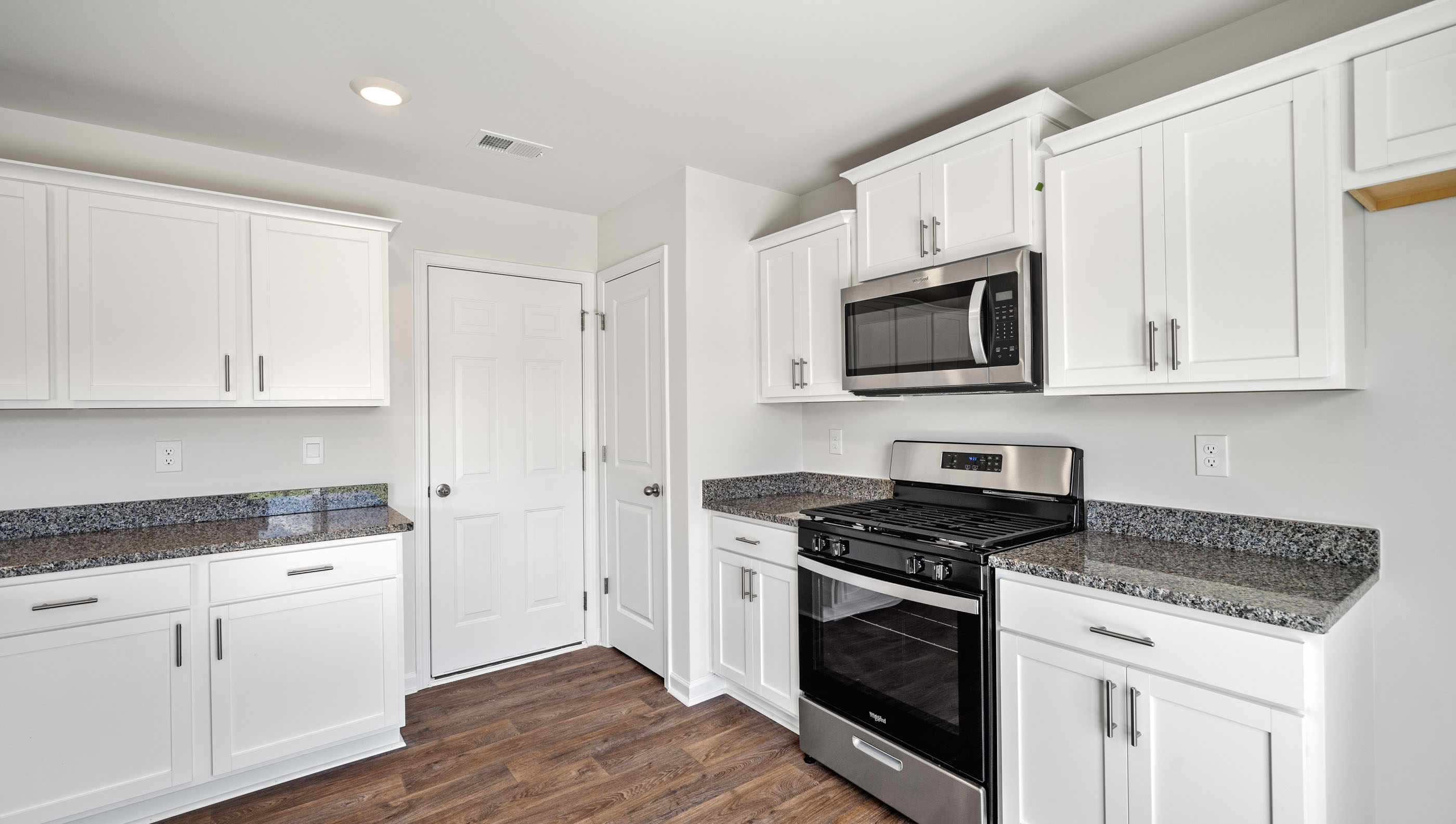 View of kitchen with cabinets and Stainless steel appliances.