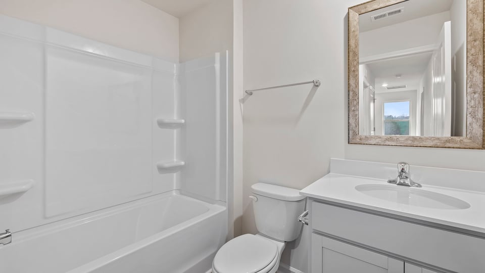 Hall bathroom with vanity and combination shower / tub.