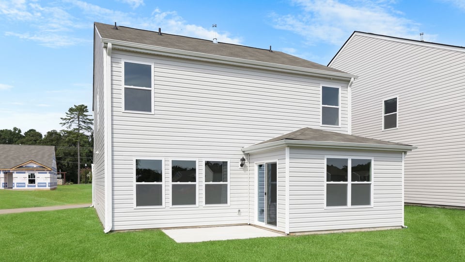 Back exterior with large backyard.