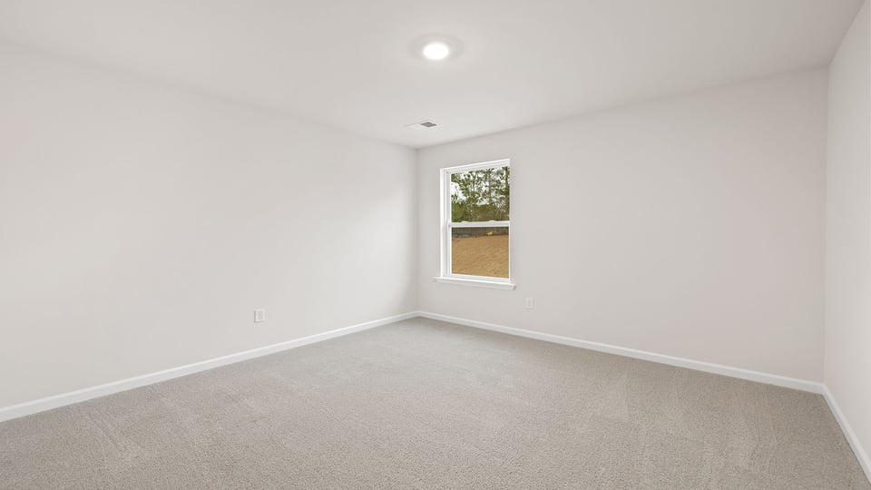 Bedroom with window and carpet.