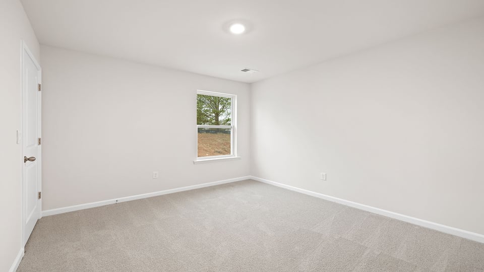 Bedroom with window and carpet.