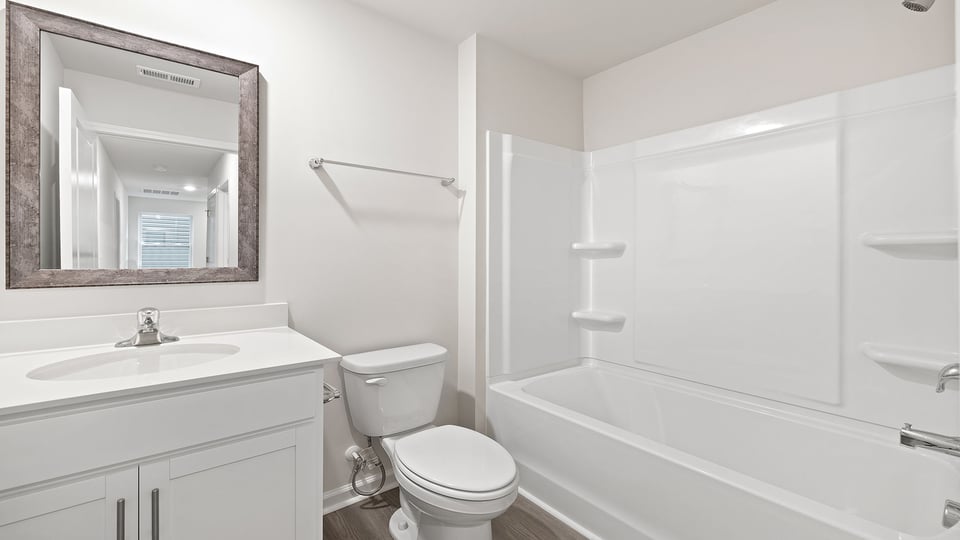 Hall bathroom with vanity and combination shower / tub.