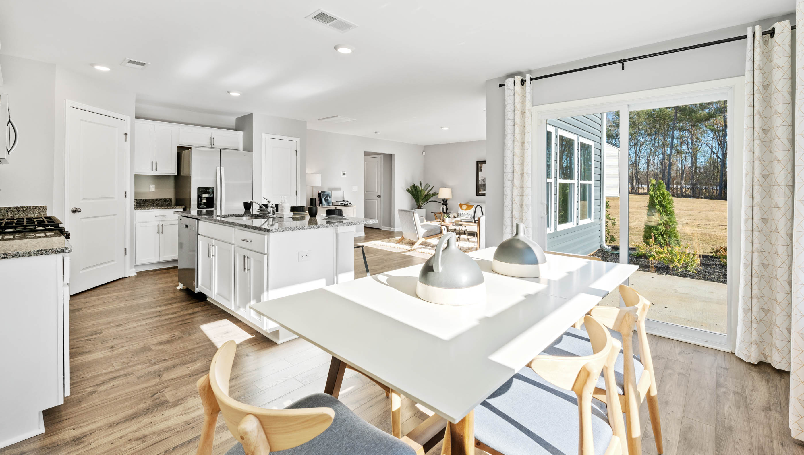 Dining room with large window and sliding door to patio.