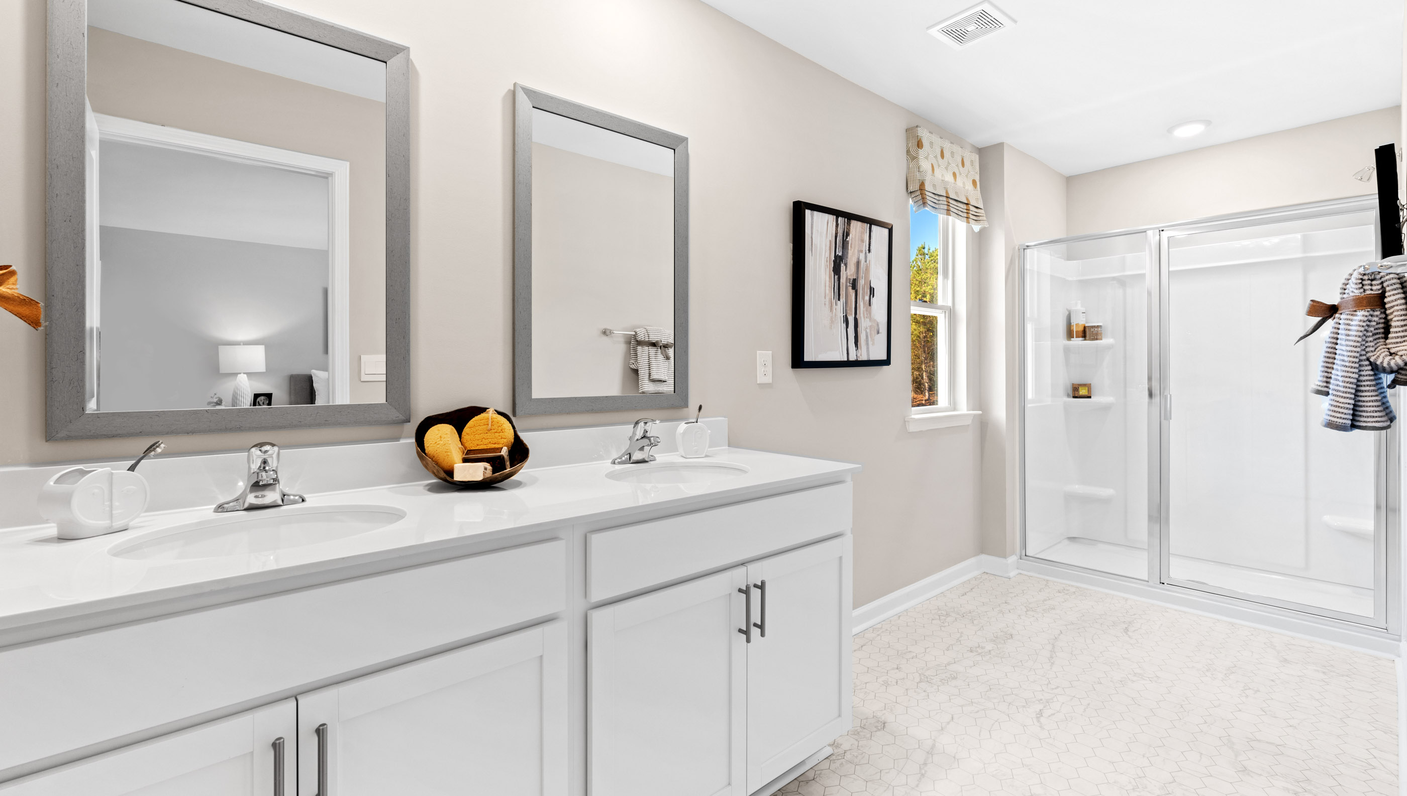 Primary bathroom with vanity and walk in shower.