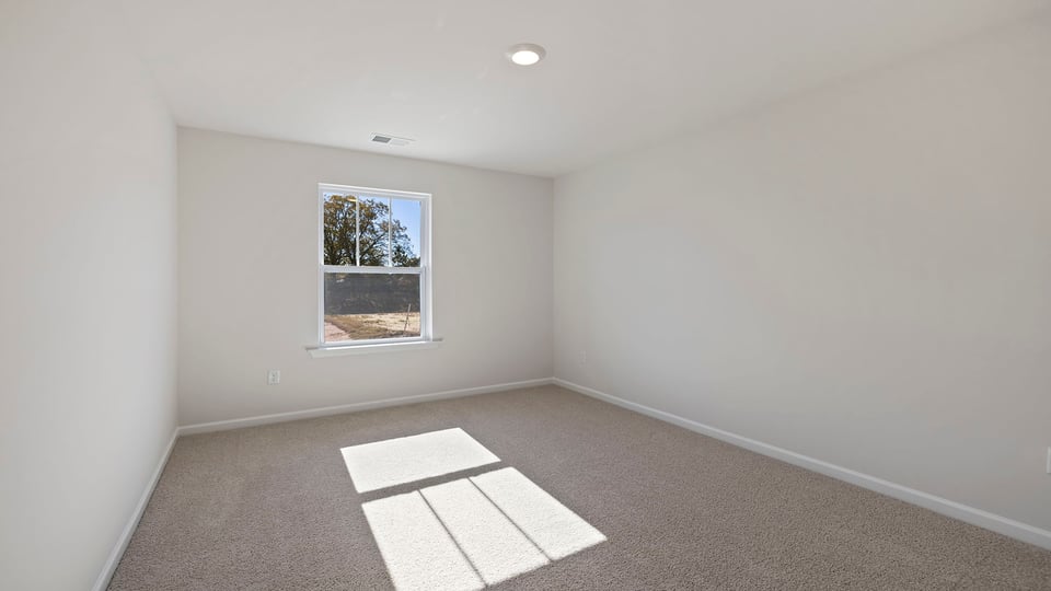 Bedroom with window and carpet.