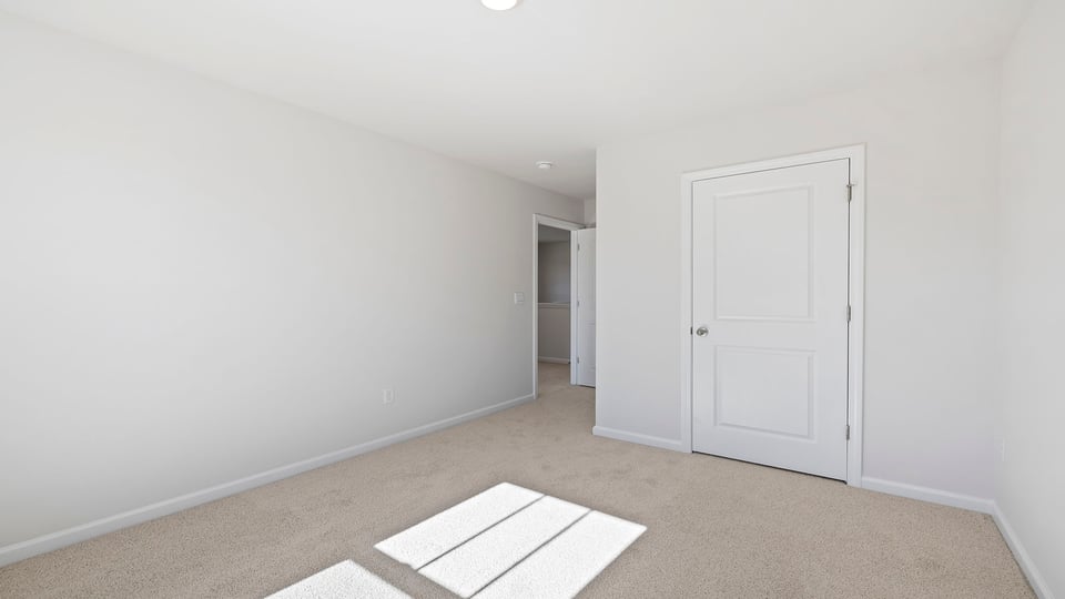 Bedroom with window and carpet.