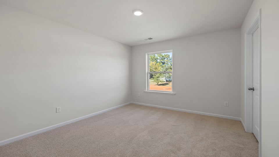Bedroom with window and carpet.