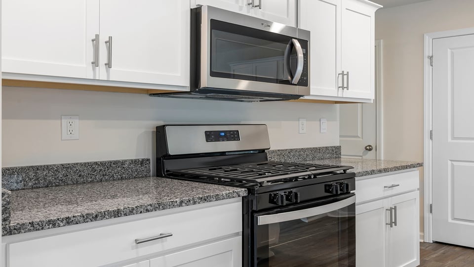 Kitchen with large island and wiindows.