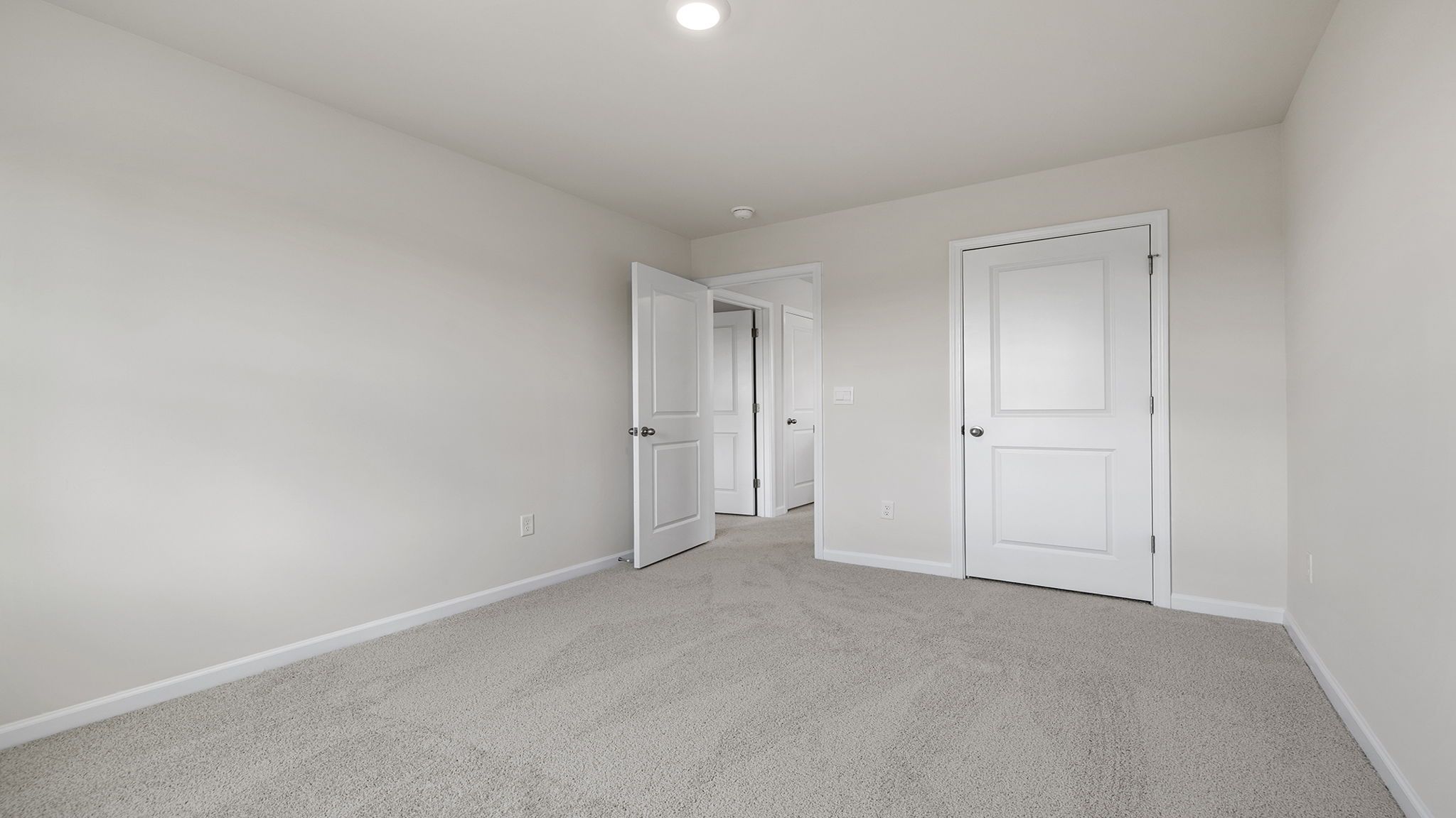 Bedroom with carpet and window.