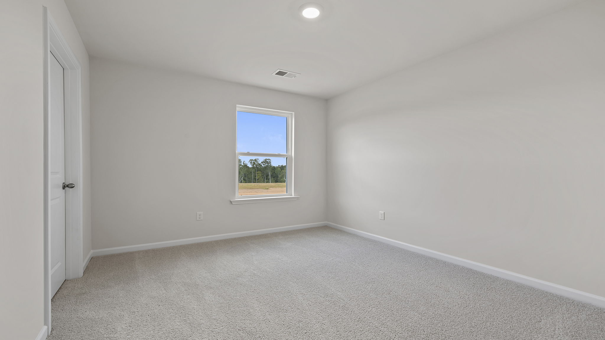 Bedroom with carpet and window.