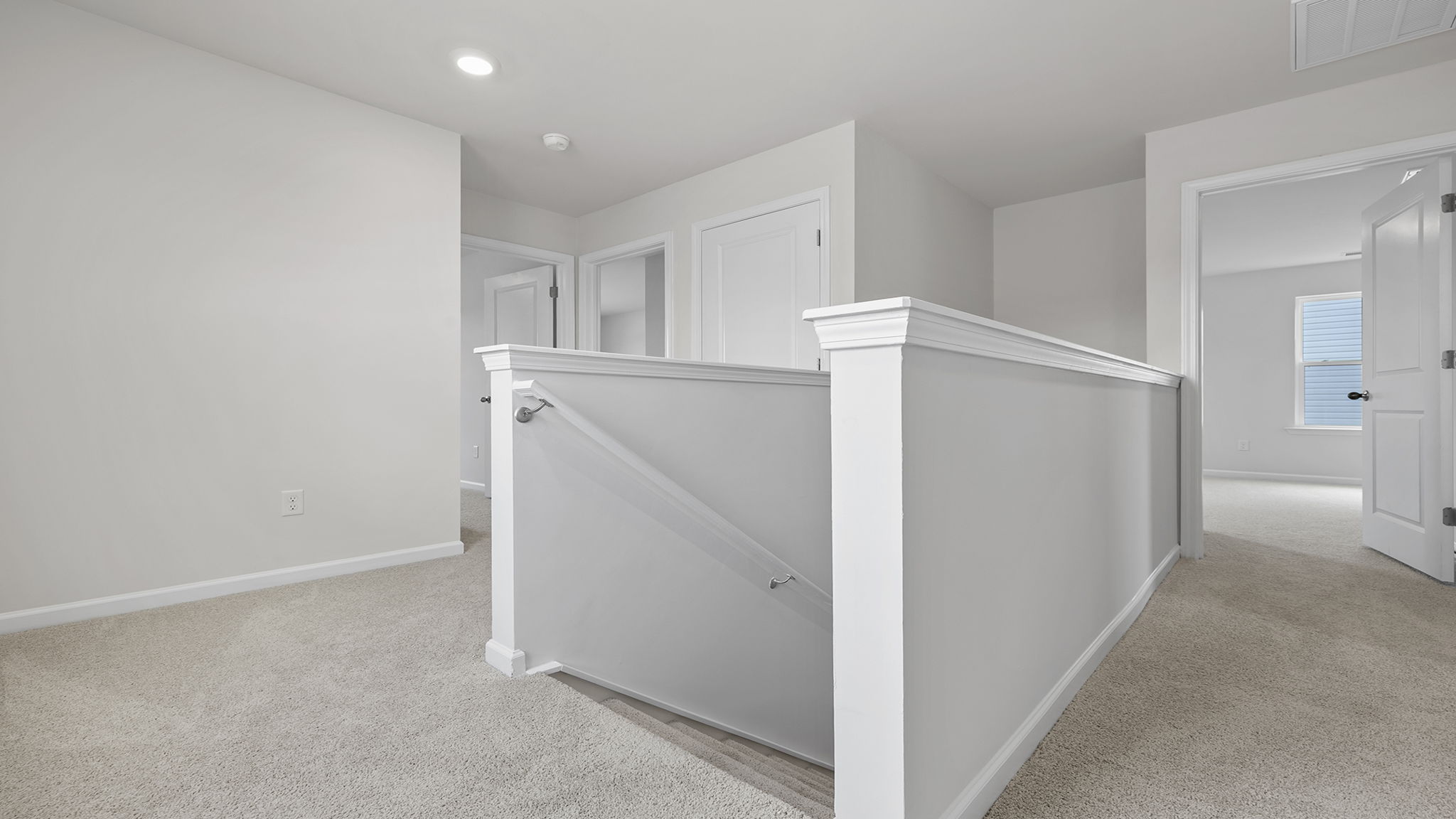 Loft area with carpet.