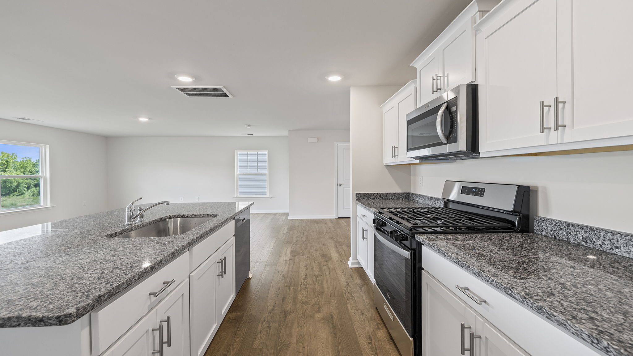 Kitchen with island and granite countertops.
