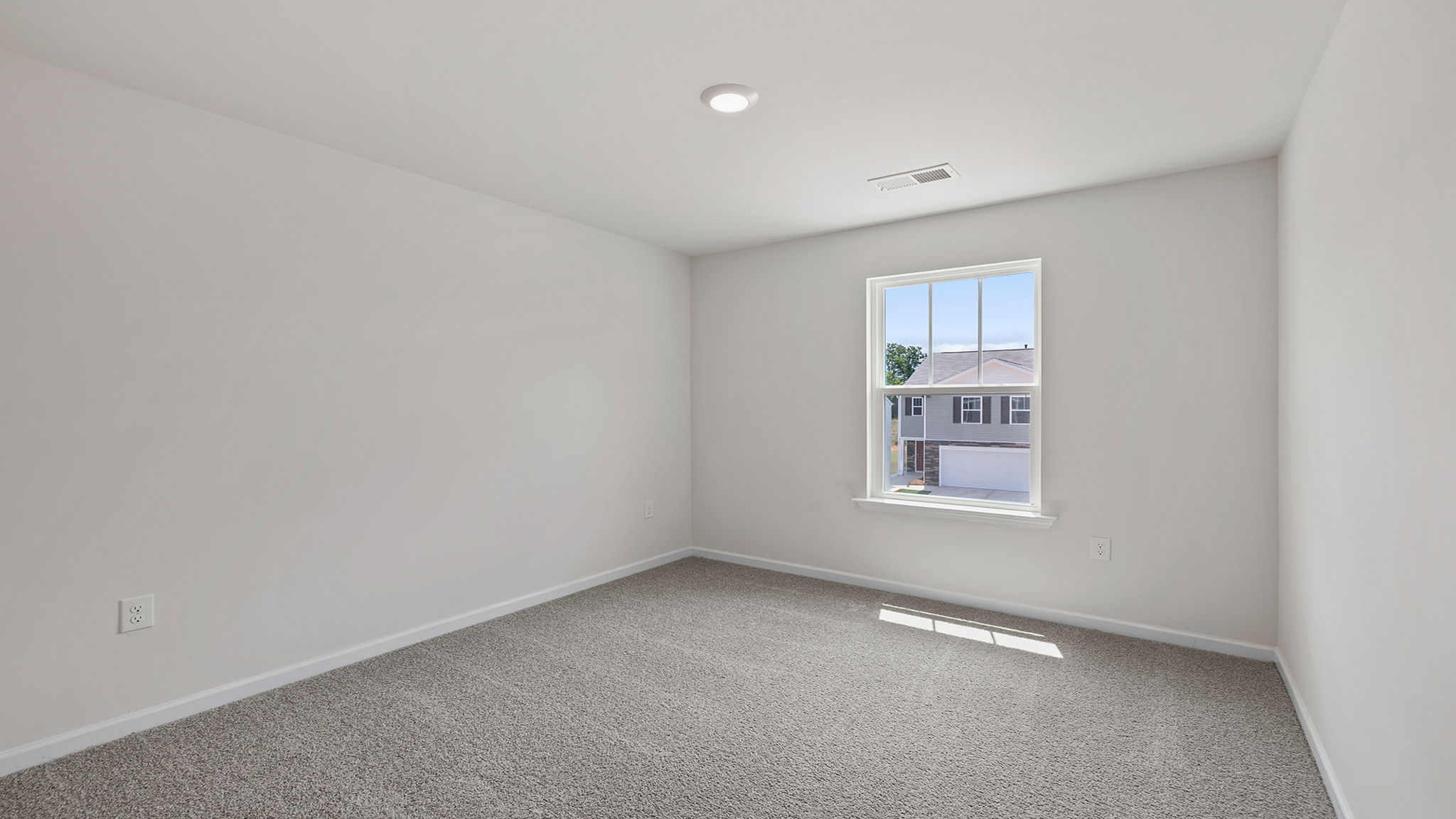 Bedroom with window and carpet.