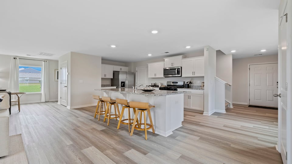 Kitchen and island with granite counter tops.