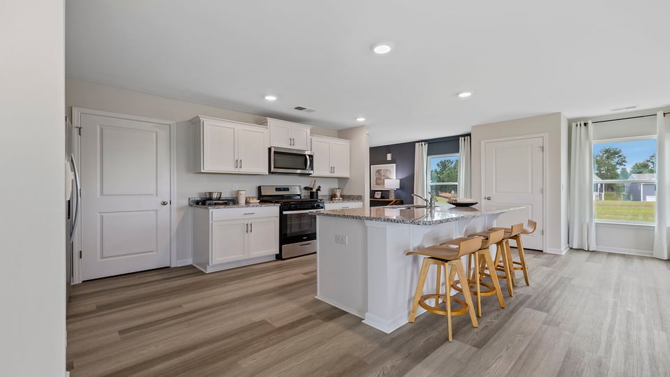 Kitchen and island with granite counter tops.