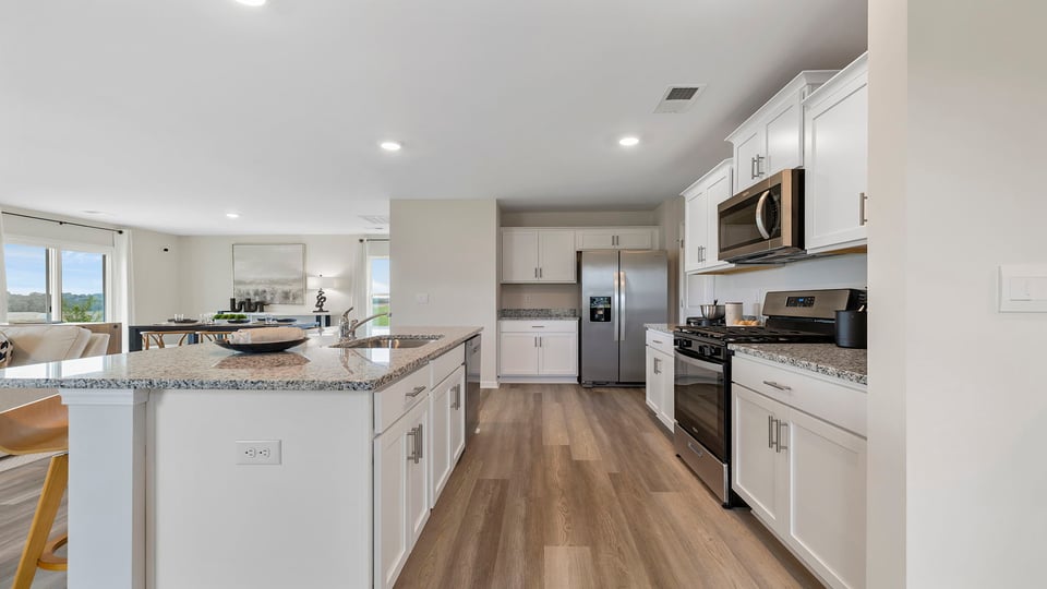 Kitchen and island with granite counter tops.