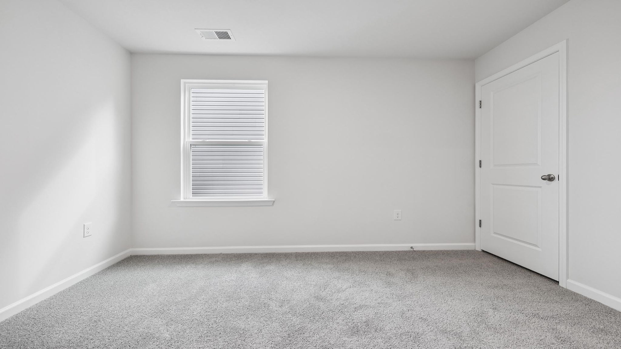 Bedroom with carpet and window.