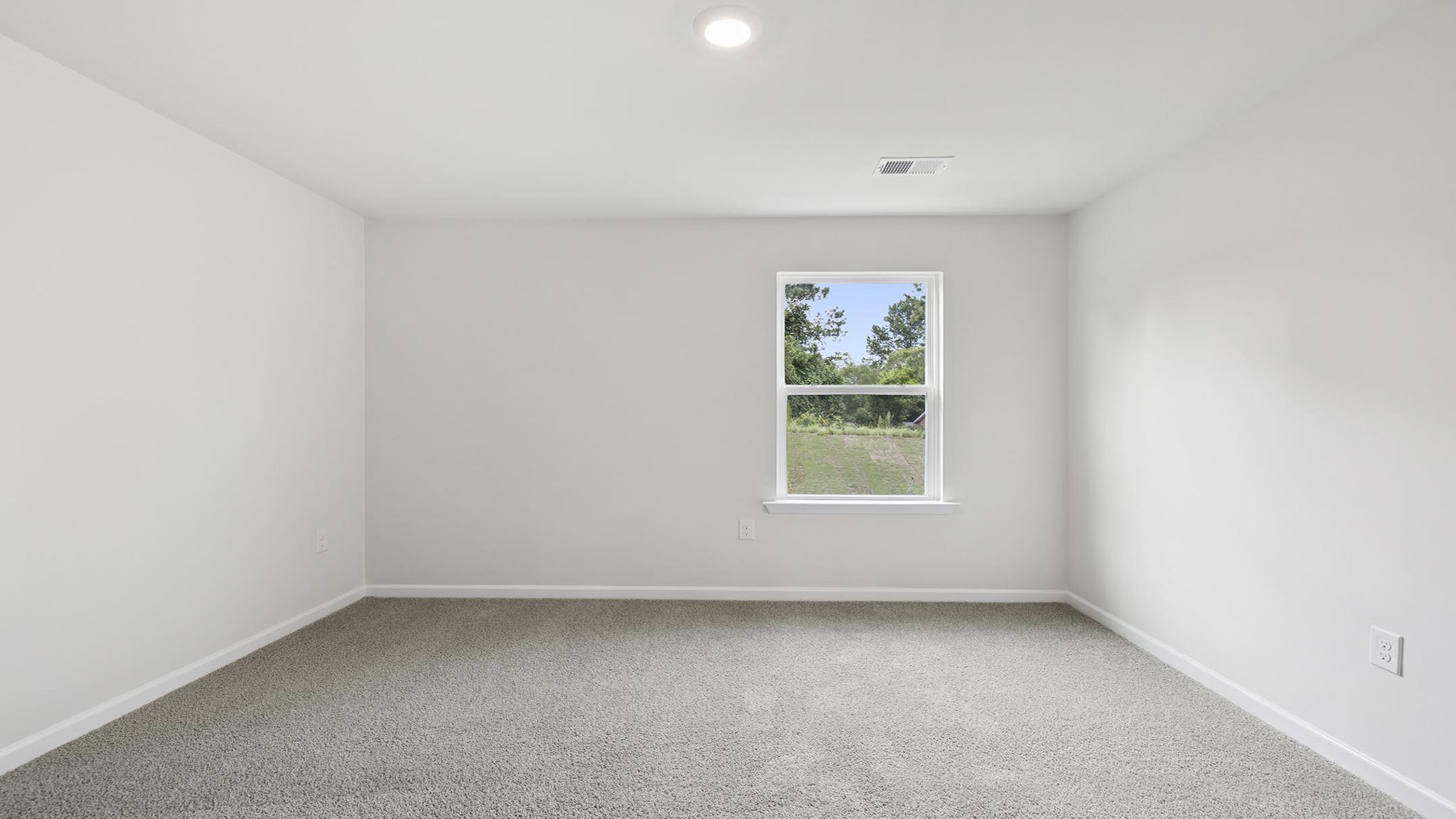 Bedroom with carpet and window.