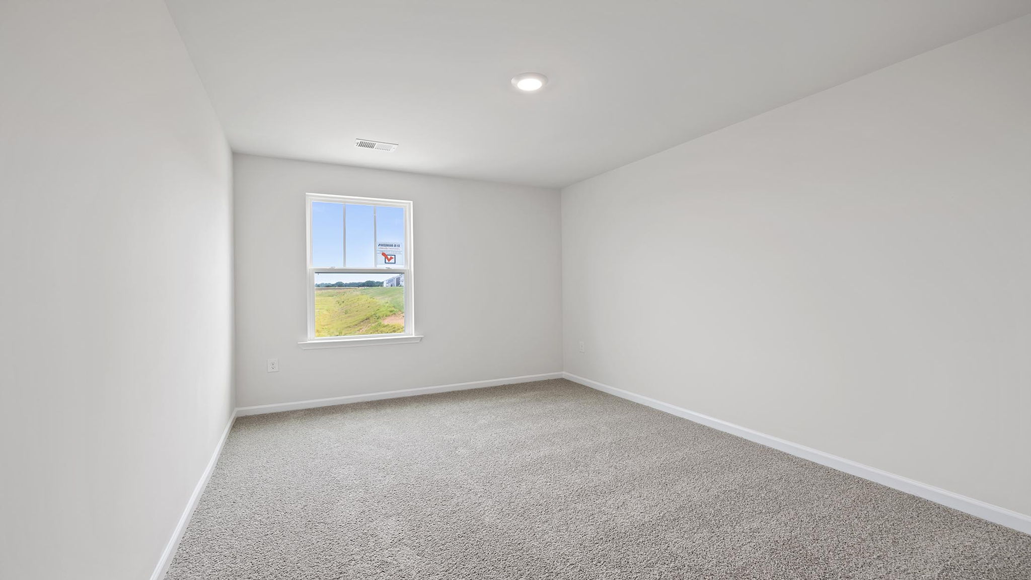 Bedroom with carpet and window.