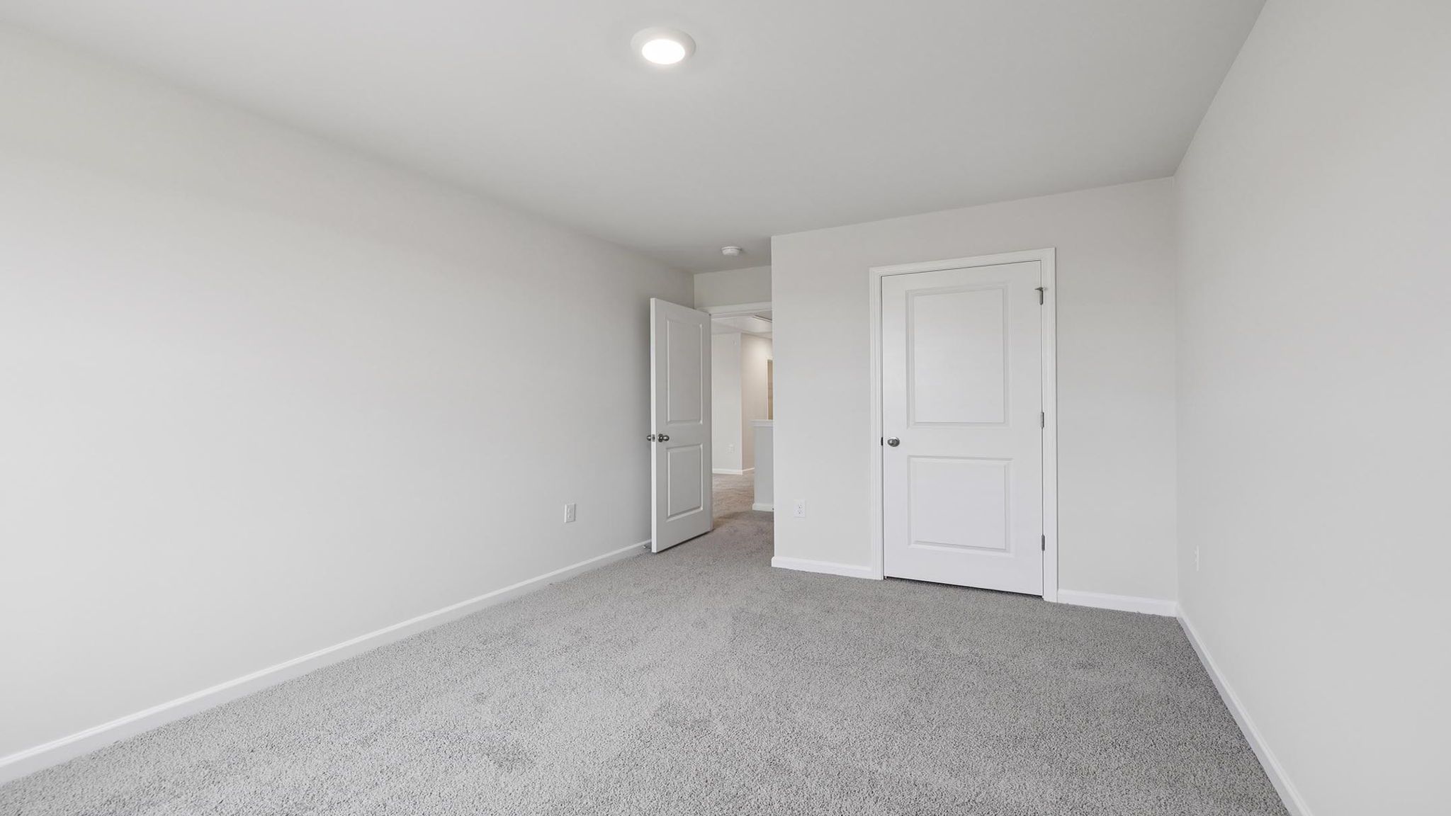 Bedroom with carpet and window.