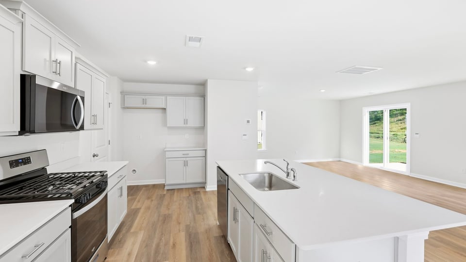 Kitchen with island and cabinets.