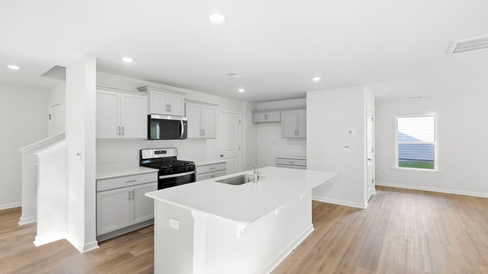 Kitchen with island and cabinets.