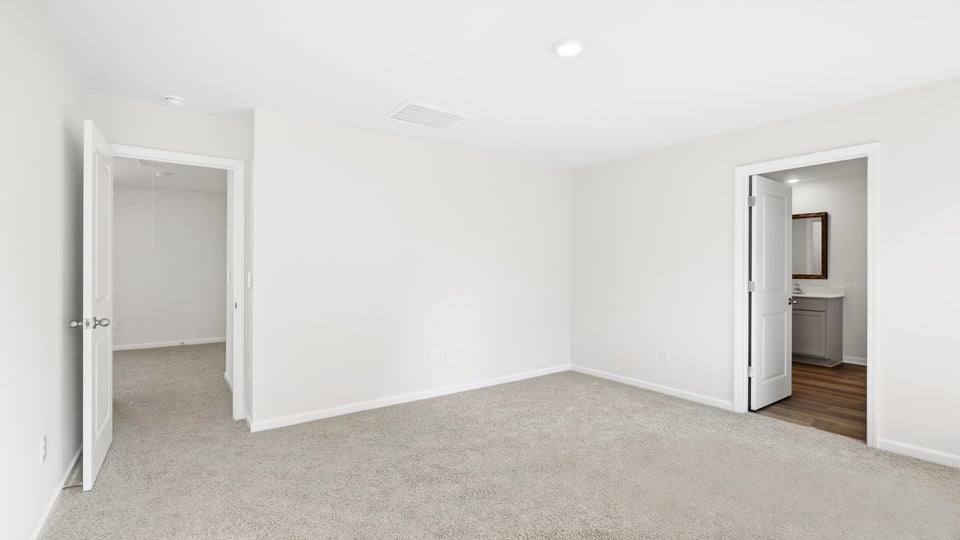 Bedroom with carpet and windows.