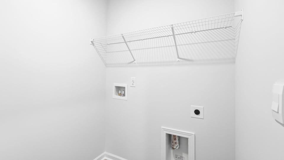 Laundry room with shelf.