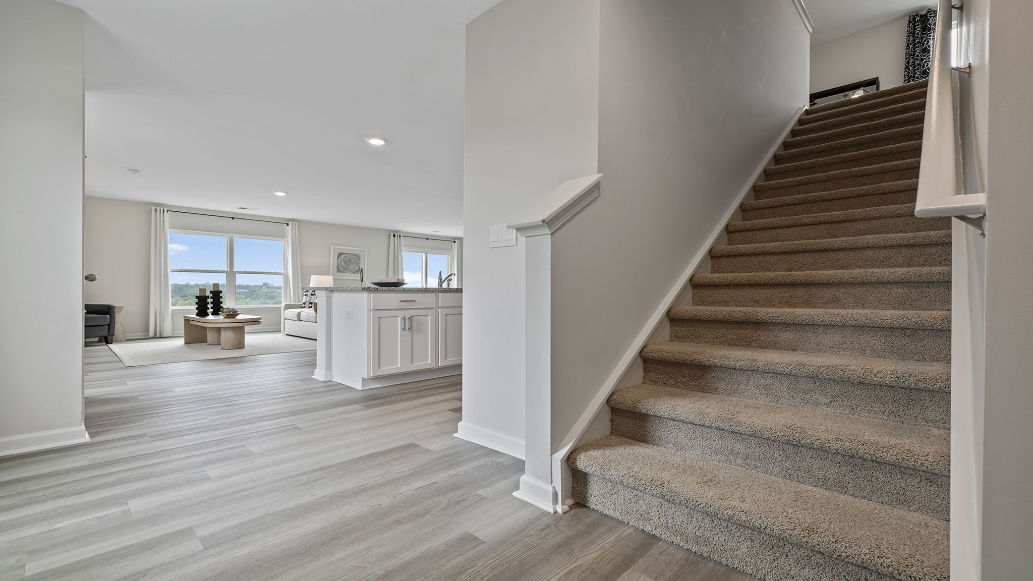 Living area with view of stairs.