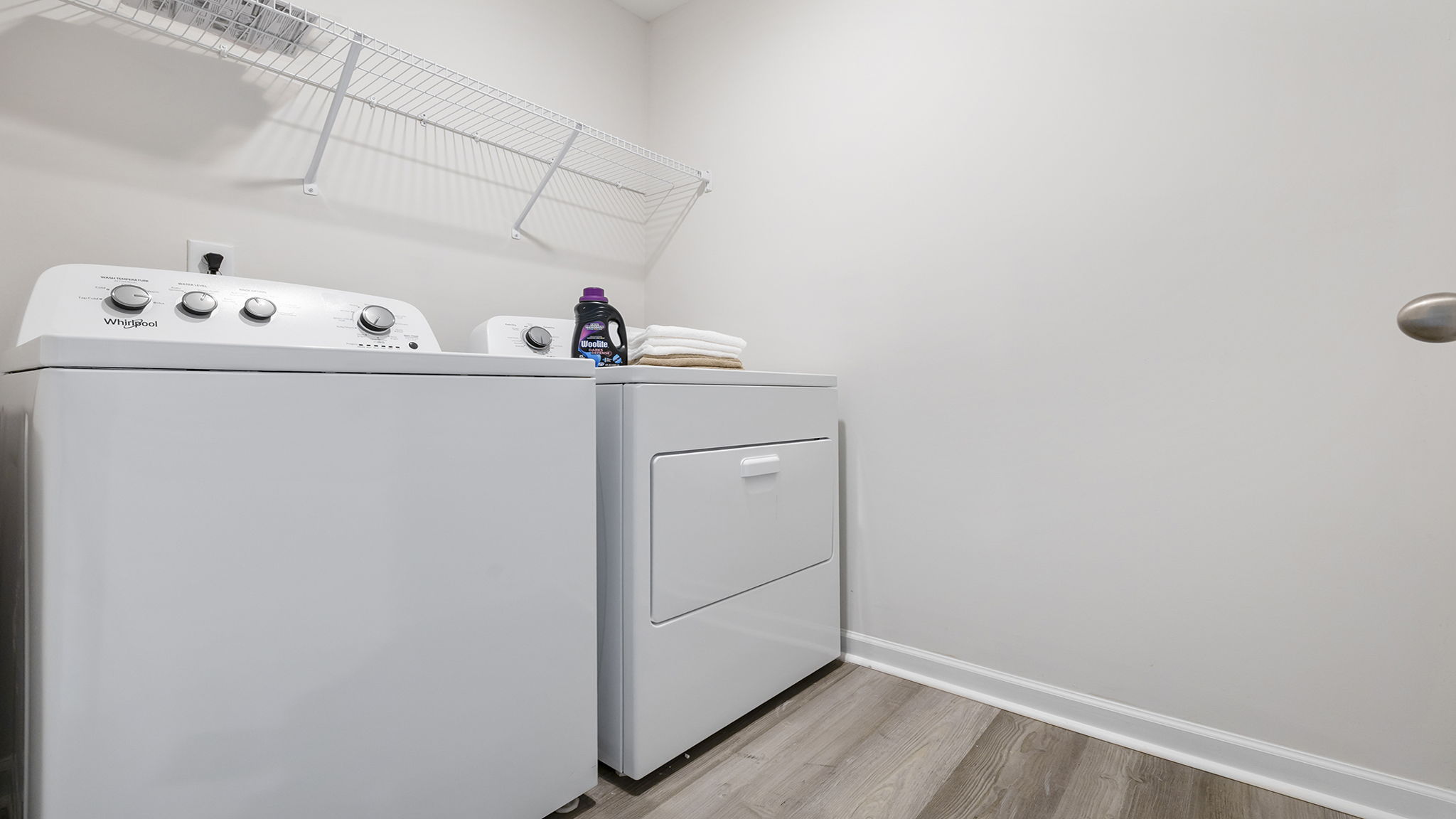 Laundry room with shelf.
