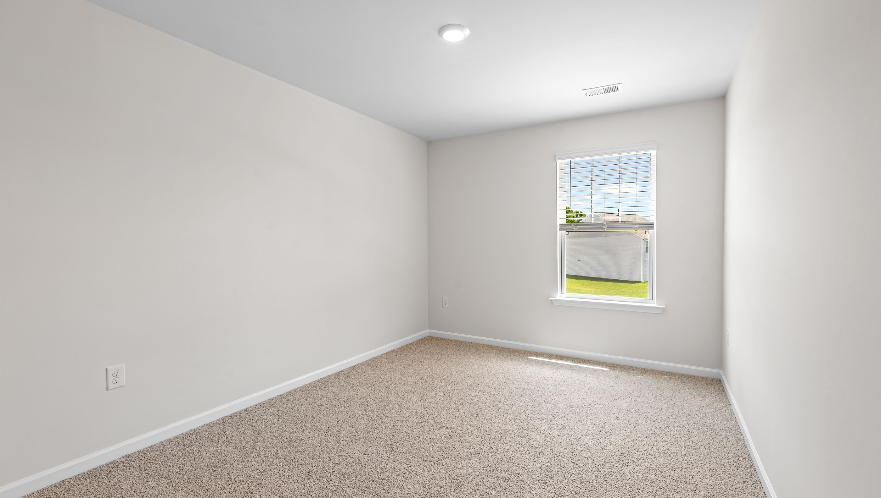 Bedroom 1 with window and carpet.