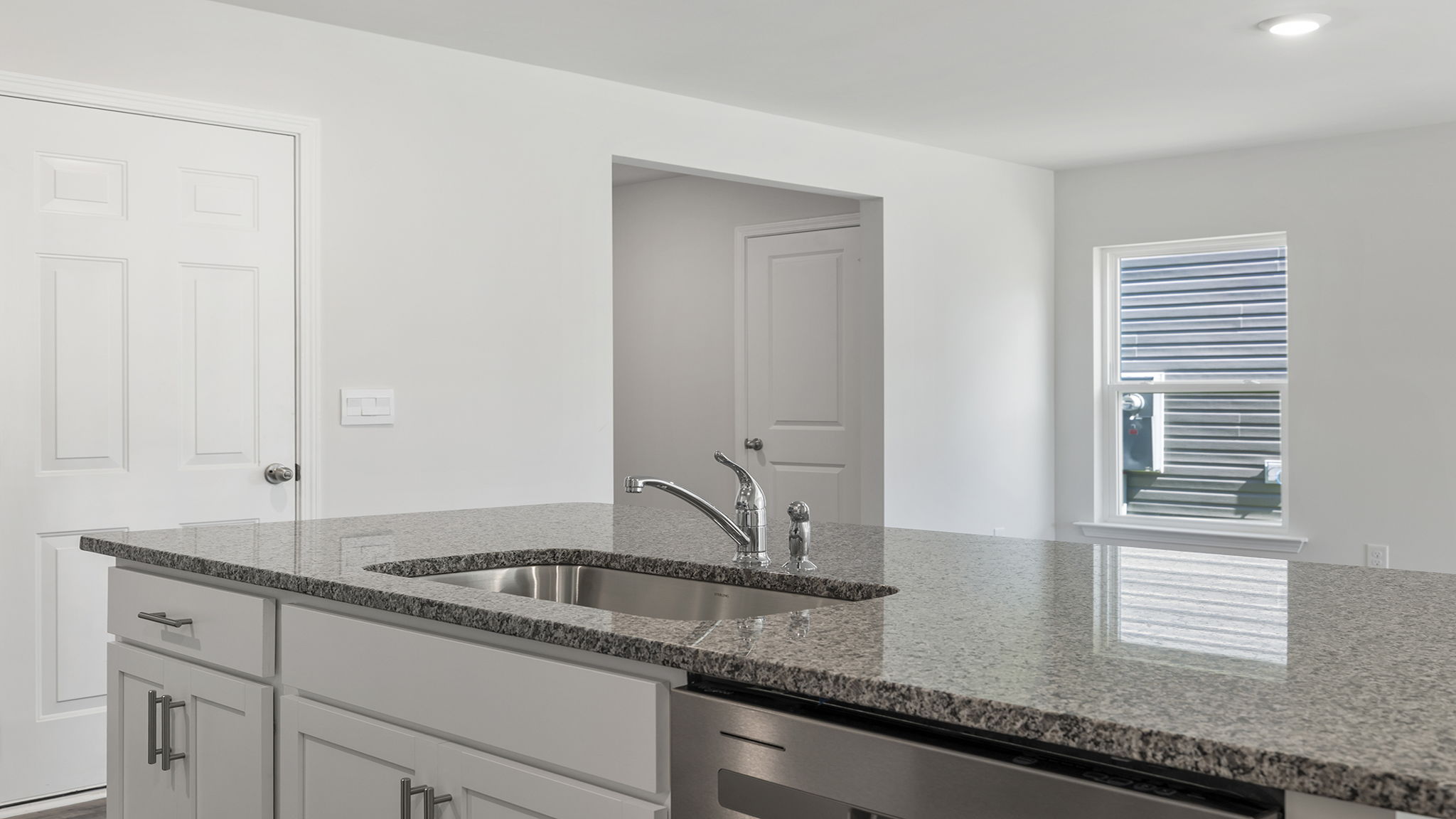 Kitchen island overlooks the dining room.