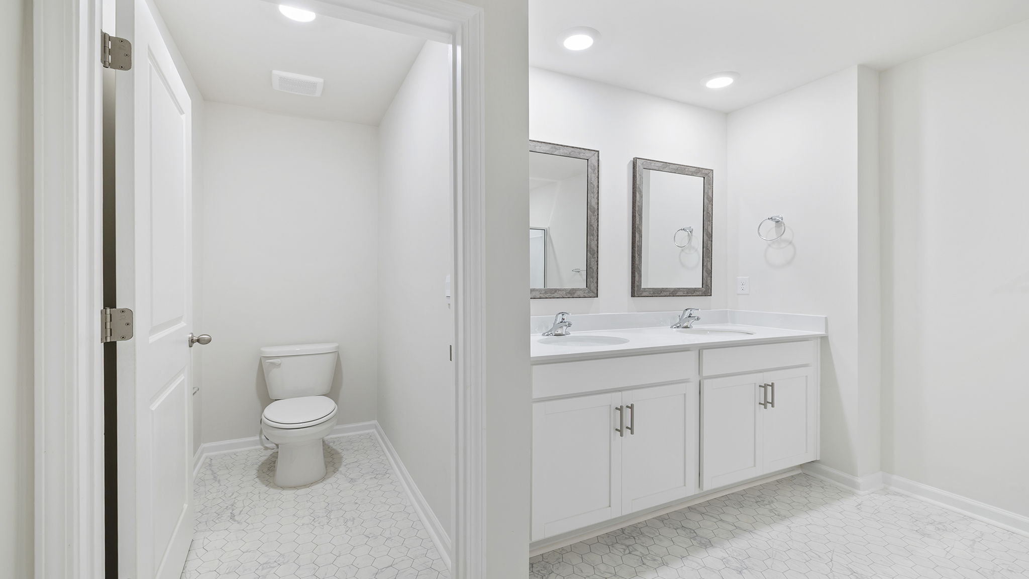 Primary bathroom with dual sink vanity.