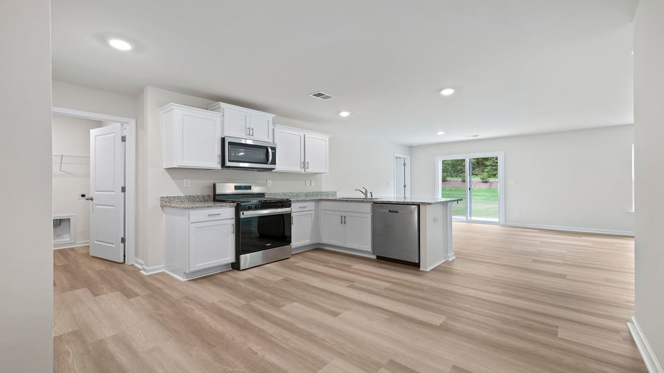 Kitchen with cabinets and window.