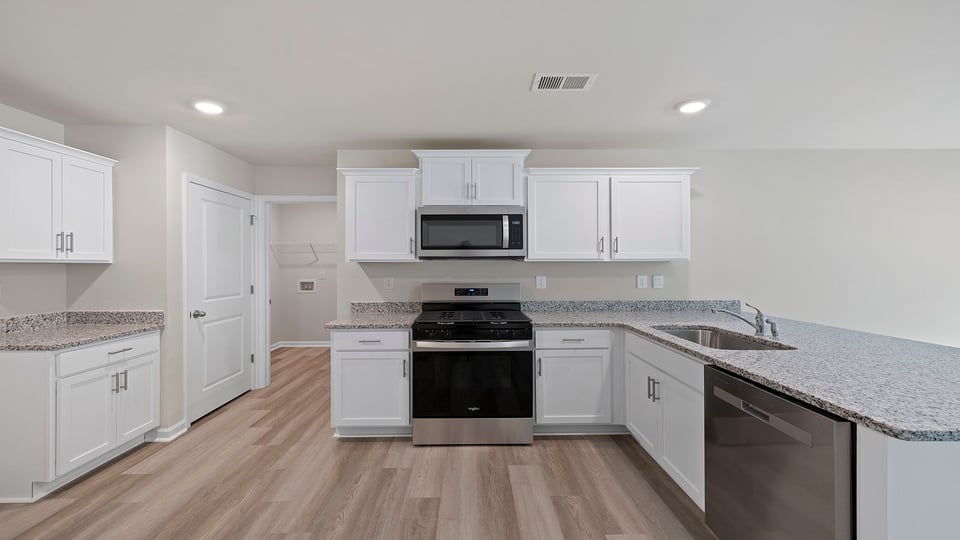 Kitchen with cabinets and window.