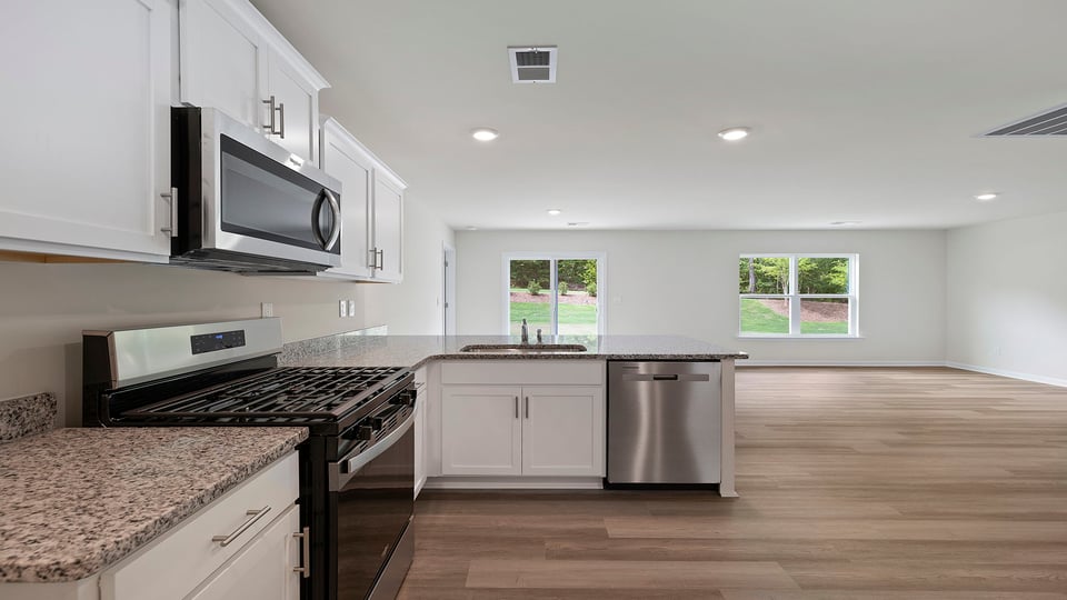 Kitchen with cabinets and window.