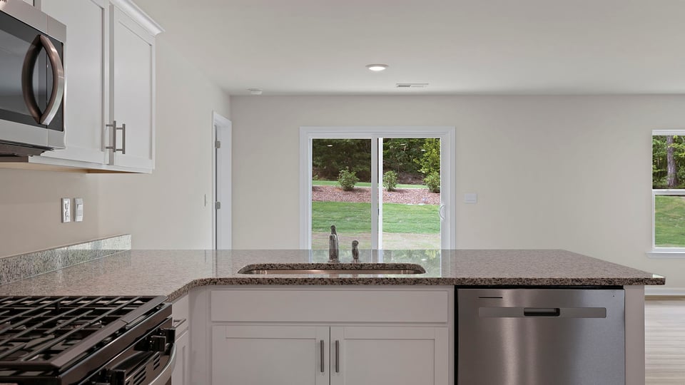 Kitchen with cabinets and window.