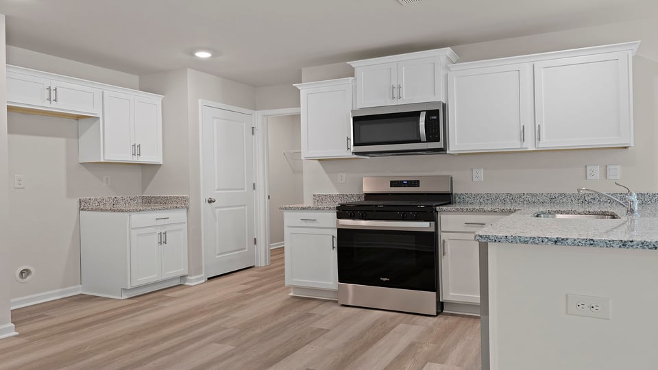 Kitchen with cabinets and window.