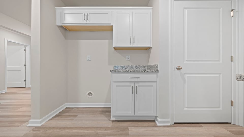 Kitchen with cabinets and window.