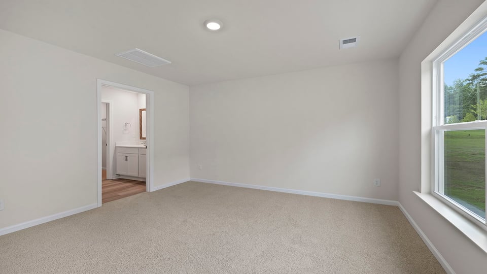 Bedroom with carpet and windows.