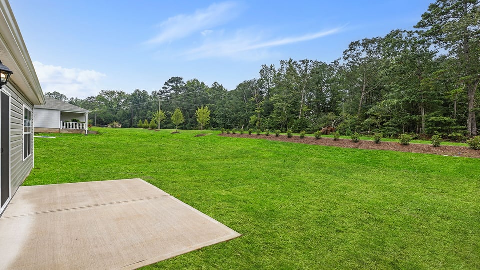 Back exterior with large backyard.