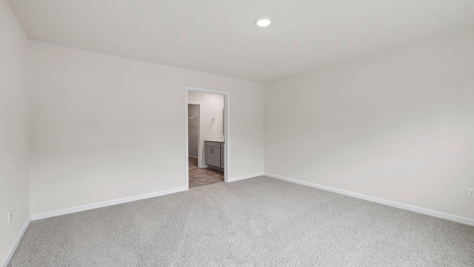 Bedroom with carpet and window.