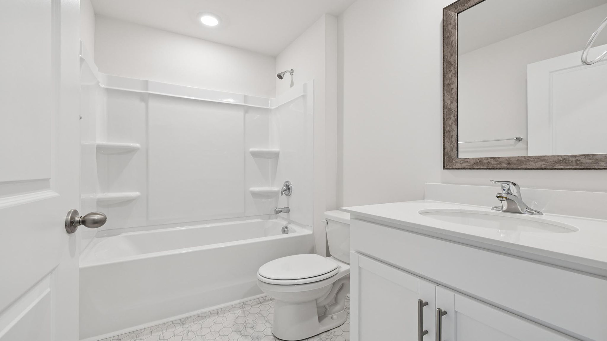 Hall bathroom with vanity and shower / tub.